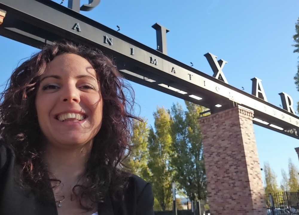 A photo of me standing in front of Pixar's campus gate on my first day of internship